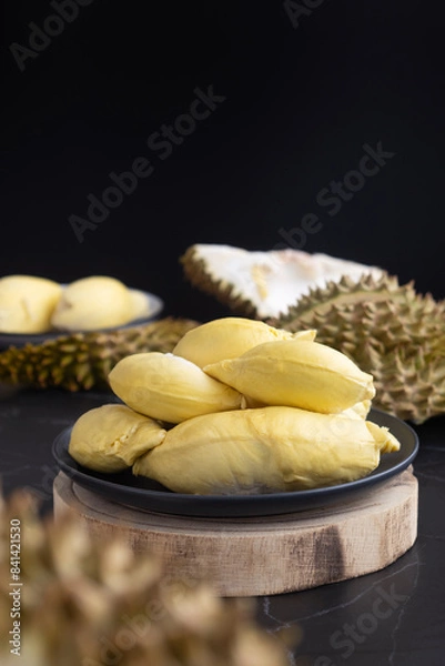 Fototapeta A fresh and ripe yellow flesh of Thai durian plate. It's a Monthong or“ Golden Pillow ”one of the most popular durians. It is the undisputed King of Fruits. It offers a sweet, creamy and buttery taste