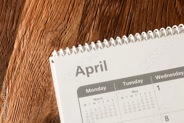 Fototapeta White calendar of the month of April on a wooden background. Planning, goal setting, agenda, planner, organization and time management concept.