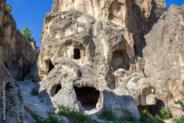 Fototapeta View of the residential areas, tombs and chapels carved from the bedrock in Ayazini Village in the Phrygian Valley