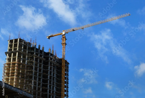 Fototapeta High-rise building under construction and crane