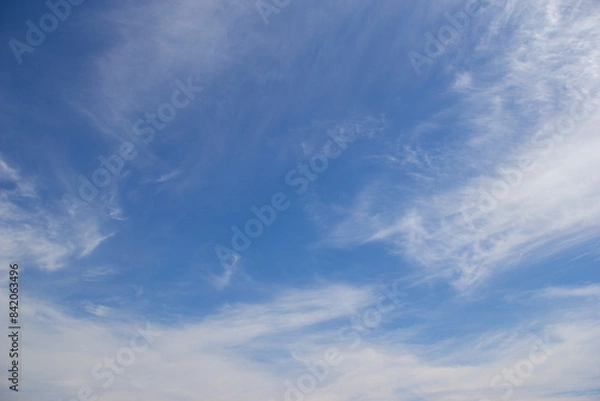 Fototapeta Wispy clouds in a blue sky