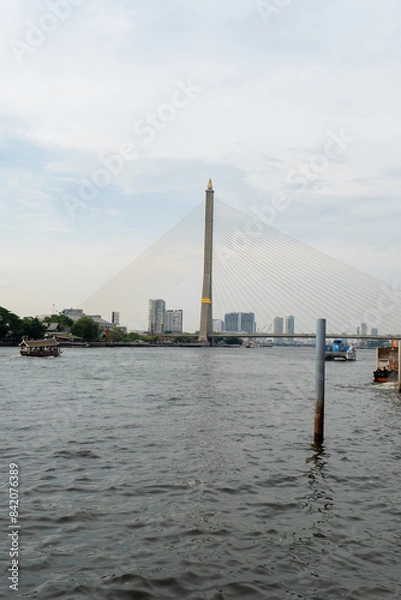 Fototapeta Bridge over the river with a pointy top and beautiful architecture watching over the city