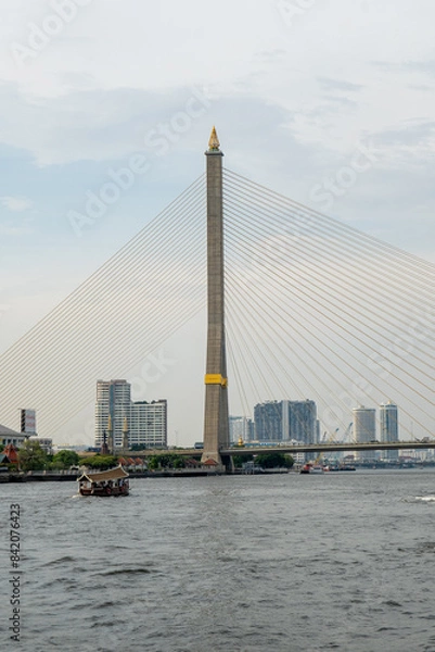 Fototapeta Bridge over the river with a pointy top and beautiful architecture watching over the city