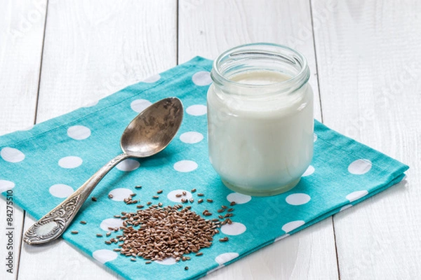 Fototapeta yogurt with flax seeds and old silver spoon