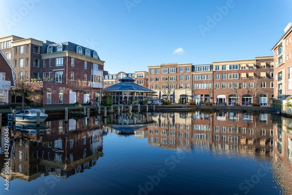 Fototapeta Reflections in the water of the harbor at the Voorhaven quarter in the center of Sassenheim, South Holland in the Netherlands