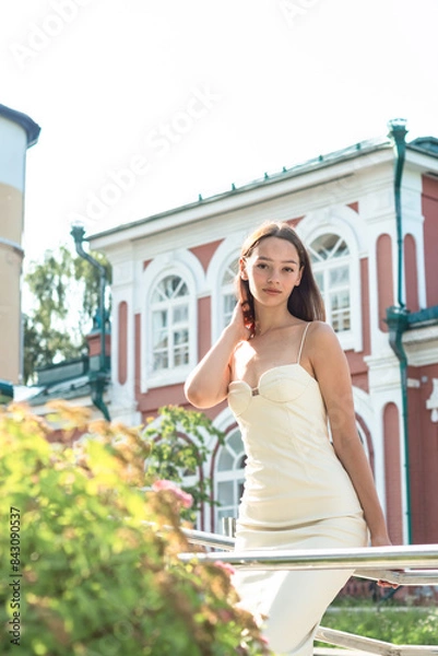 Obraz The girl walks around the summer city.