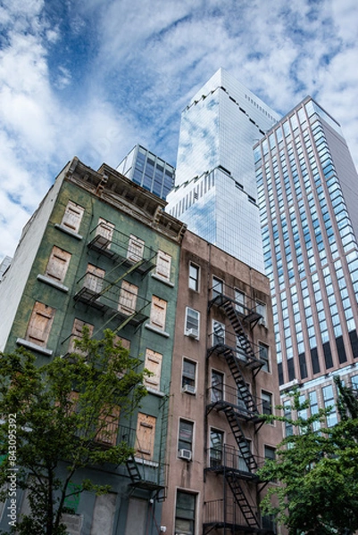 Fototapeta Old and new buildings in manhatten New York skyline. Urban cityscape with historic as well as mordern skyscapers.