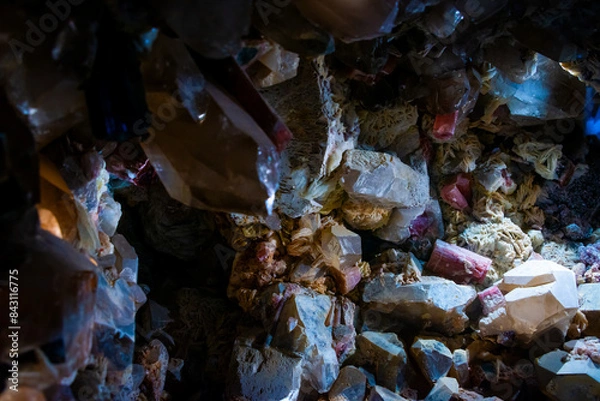Fototapeta small mineral cave with different color gems. Raw crystals and other stones.