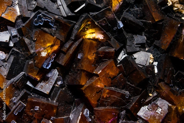 Fototapeta Dark mineral gem close up making a interesting background in geology. Unpolished Crystals as found in nature.