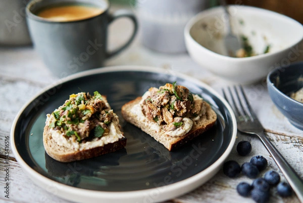 Fototapeta delicious homemade open face sandwich, topped with smashed sardine and olive oil