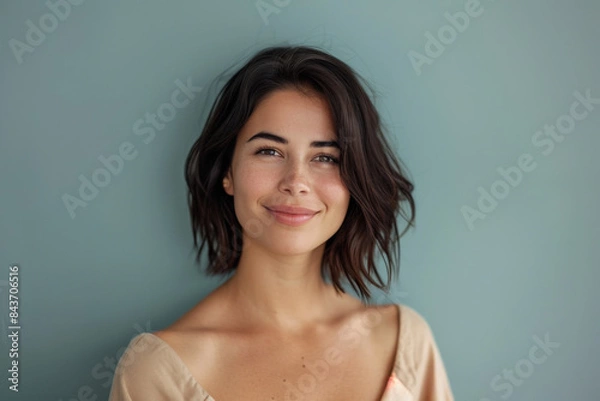 Fototapeta A close up portrait of a young woman with a subtle smile