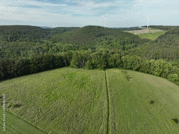 Fototapeta Windkraftanlagen mitten im Grün umgeben von Gebirgen in Rheinland-Pfalz