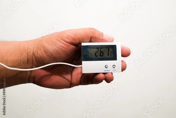 Obraz man's hand holding a temperature measuring device