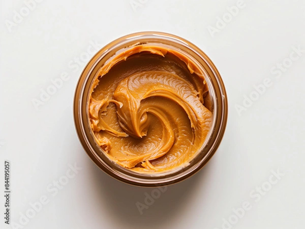 Fototapeta Arrange a Clear Nut Butter Jar Against a Plain White Background - Simple Elegance
