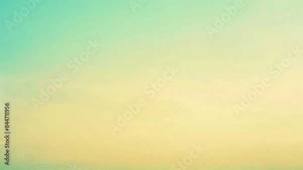 Fototapeta A serene beach landscape with a calm sea under a clear sky with a gradient of yellows and greens, ideal for relaxation.
