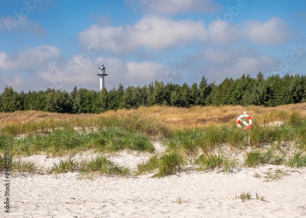 Fototapeta Lighthouse and lifebuoy at Dueodde beach on the island Bornholm, Denmark.