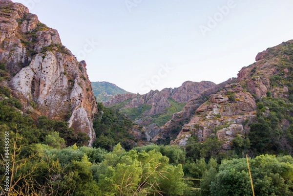 Fototapeta Views of the rough and rocky terrain, with the lush foliage, along with the creek, at Malibu Creek State Park