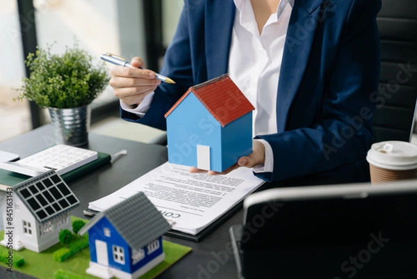 Fototapeta Real estate broker agent presenting and consult to customer to decision making sign insurance form agreement, home model,