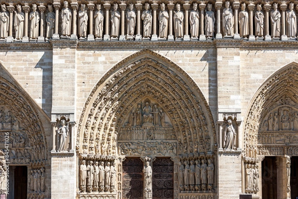 Fototapeta Fragment of a sculptural panel of a portal of the main facade of Notre-Dame de Paris with the image of a scene of the Last Judgement, Paris, France