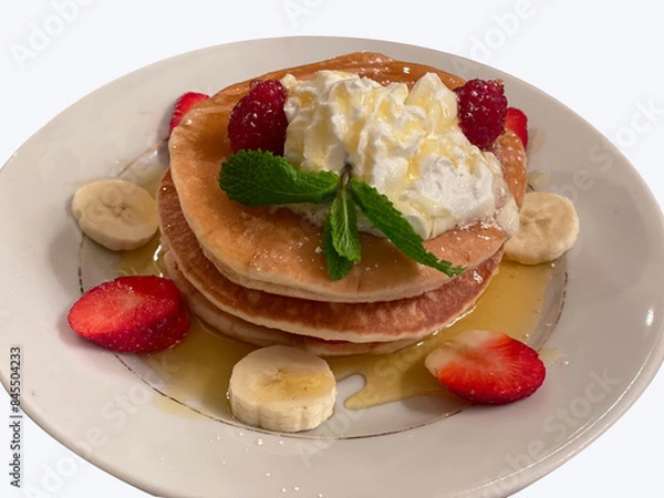 Fototapeta Pancakes topped with honey Serve with strawberries and banana slices.