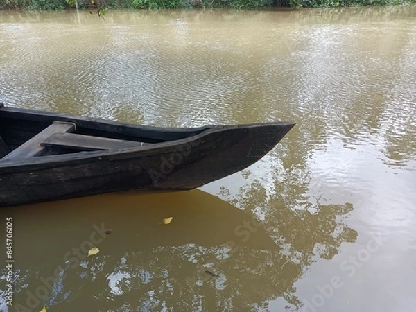 Fototapeta A canoe is a lightweight narrow water vessel, typically pointed at both ends and open on top, propelled by one or more seated or kneeling paddlers facing the direction of travel and using paddles.