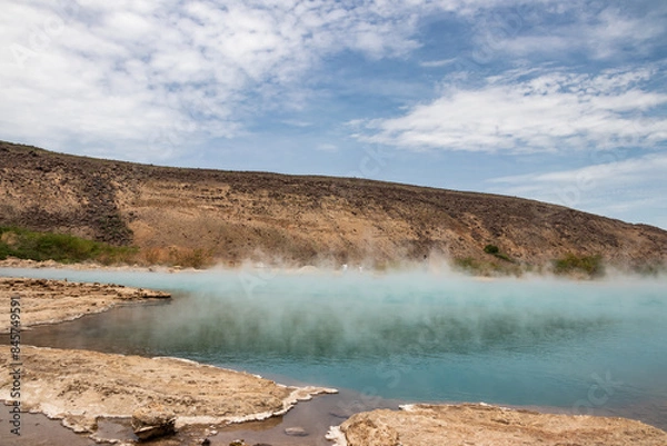 Fototapeta Alolabad geothermal area in Ethiopia with surreal landscape of colorful hot springs, steaming fumaroles, and erupting salt geysers in an arid, remote desert setting below sea level, Afar desert