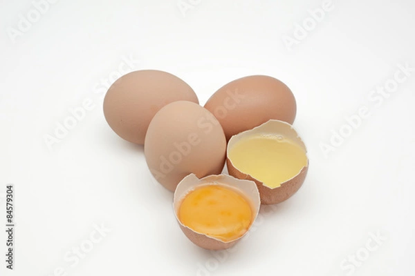 Fototapeta Broken egg isolated on white background. separated egg white and yolk