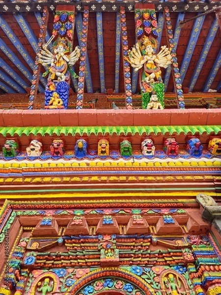 Fototapeta typical Hindu Buddhist temple of Nepal, with structure made of wood and stone, all coloured, full of masks representing different gods