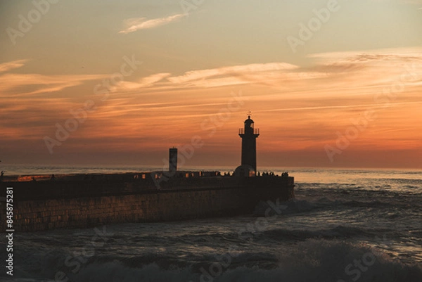 Obraz Sunset in the ocean by the lighthouse