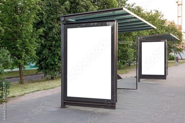 Fototapeta Two Blank Mockups Of Bus Stop Advertising Poster Billboards. White Empty Outdoor Ad Lightboxes On The Sidewalk
