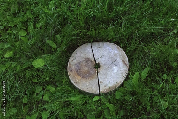 Obraz Broken stone wheel on grass