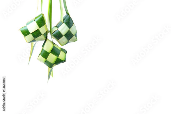 Obraz Ketupat wrapped in coconut leaves on a white background.