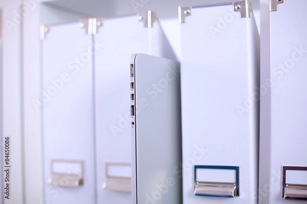 Obraz File folders, standing on  shelves in the background