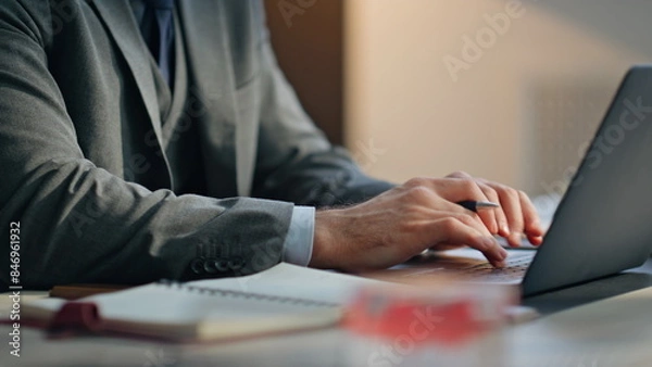 Fototapeta Closeup man hands typing laptop keyboard taking notes writing at office desk