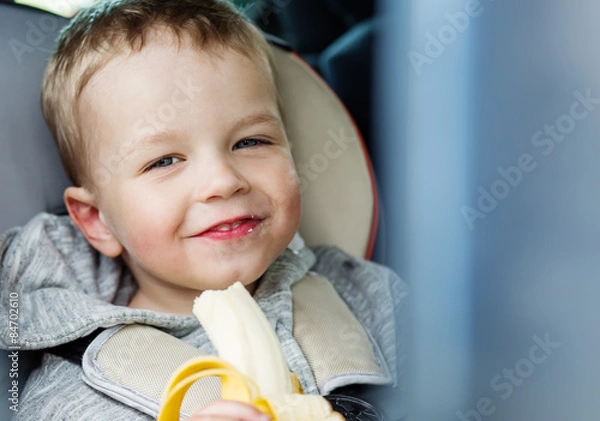 Fototapeta Happy Toddler boy  in the car