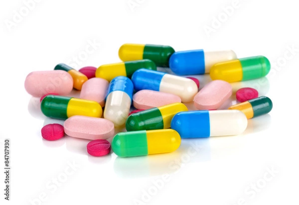 Fototapeta Colored pills, tablets and capsules on a white background