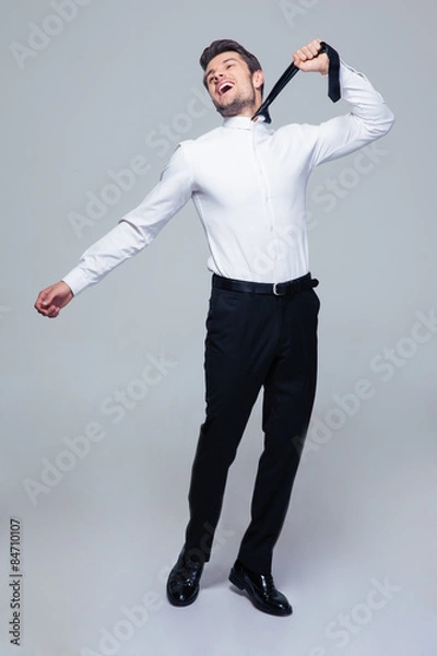 Fototapeta Young businessman to hang himself with tie