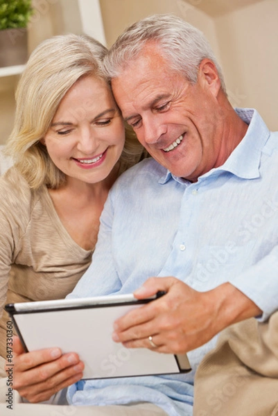Fototapeta Happy Senior Man and Woman Couple Using Tablet Computer at Home