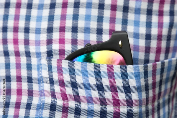Obraz Sunglasses in a shirt pocket.