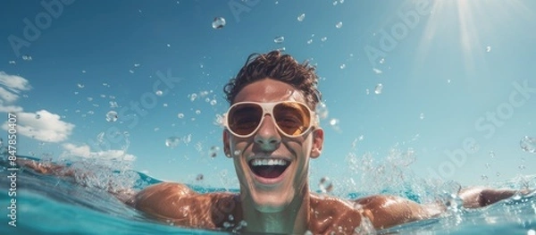 Obraz A young man enjoying the swimming pool hodays concept. Creative banner. Copyspace image