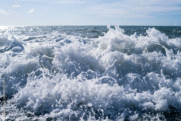 Fototapeta Sea wave close-up, water splash in the sea, sea foam against the sky on a summer sunny day