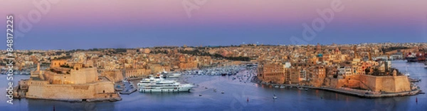 Fototapeta View to Grand Harbor from the walls of Valletta Fortress at sunset.