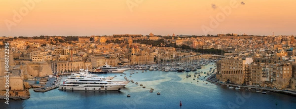 Fototapeta View to Grand Harbor from the walls of Valletta Fortress at sunset.
