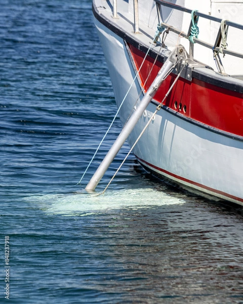 Fototapeta Fishing boat with an aluminium stabilizer deployed.