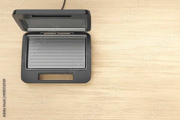 Fototapeta Empty electric sandwich maker on wooden table