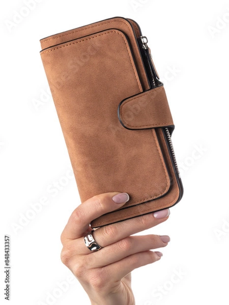 Fototapeta Close-up of female hand elegantly holding textured vibrant brown suede wallet with multiple compartments isolated against white background. Concept of brightness and individuality in personal style