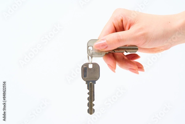 Fototapeta 住宅の鍵を持つ女性の手元