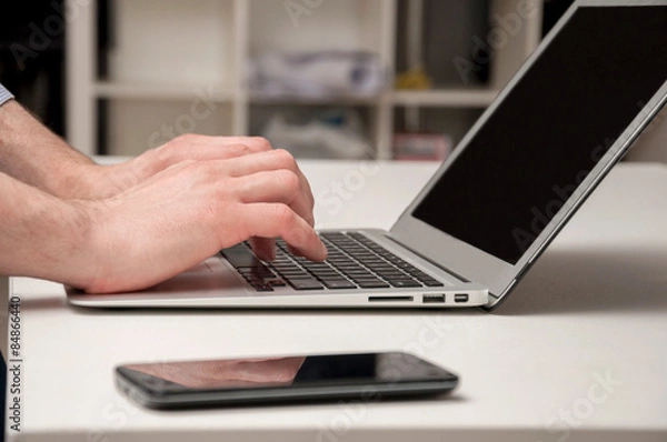 Fototapeta Man's hands typing on laptop. Internet surfing