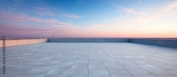 Fototapeta Modern building rooftop on an empty floor set against a picturesque evening sky offers a stunning copy space image