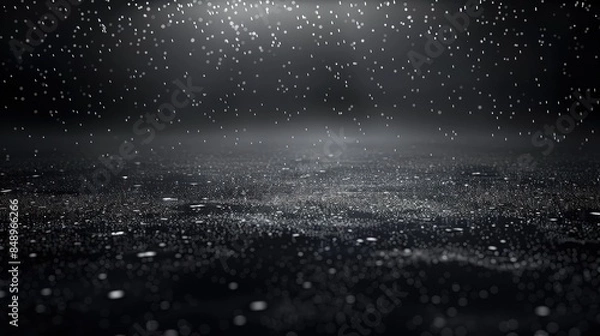 Fototapeta A black abstract background with a subtle gradient into deep charcoal, featuring silver particles that mimic a gentle rainfall in a dark night sky.